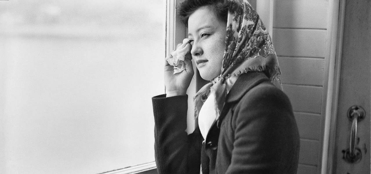 Woman looking out a window.